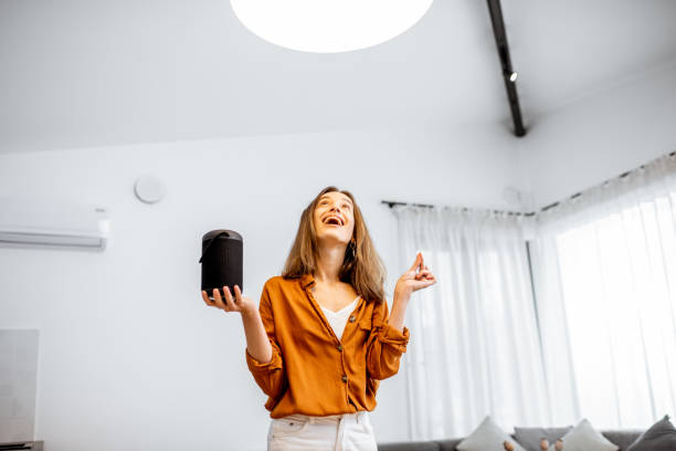istock Woman controlling light with a smart speaker at home 1193467402