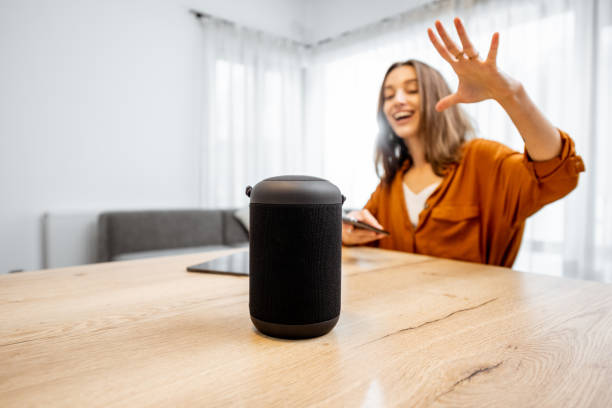 istock Woman controlling home devices with a voice commands 1193467441