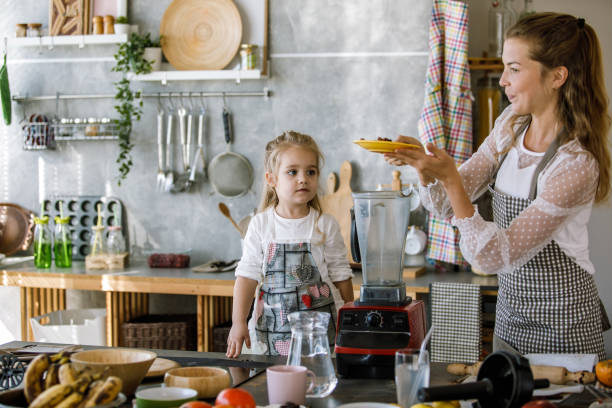 istock Mother and toddler daughter making hazelnut milk 1193467518