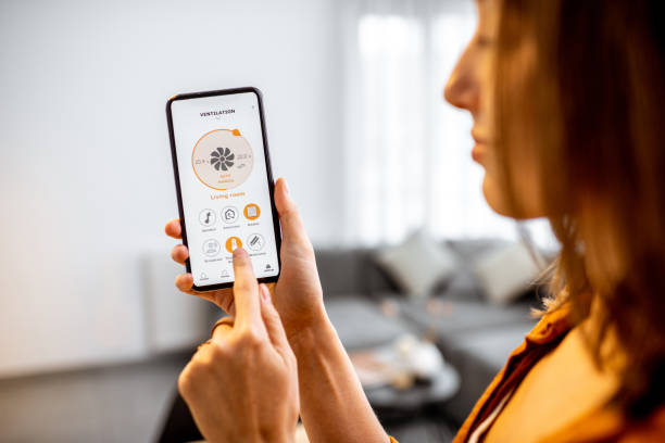 istock Woman controlling ventilation with a smart phone at home 1193467525