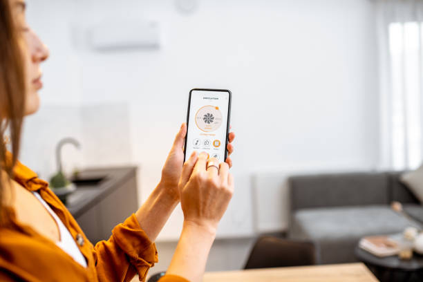 istock Woman controlling ventilation with a smart phone at home 1193467543