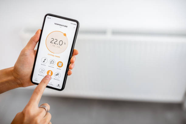 istock Controlling heating with a smart phone at home 1193467584