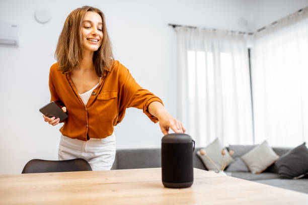 istock Woman with smart wireless column at home 1193468217
