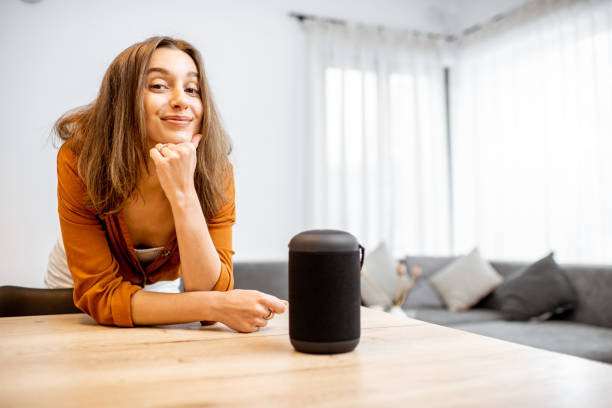 istock Woman with smart wireless column at home 1193468243