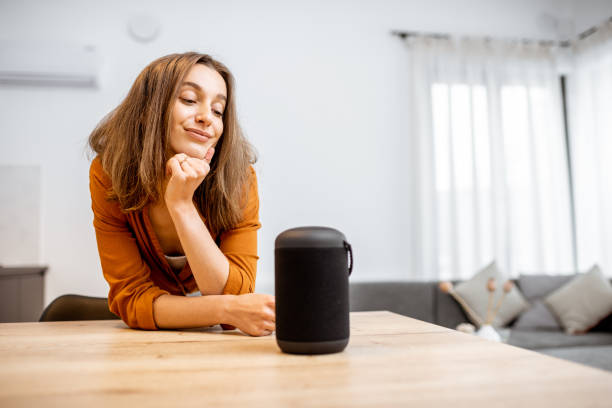 istock Woman with smart wireless column at home 1193468251