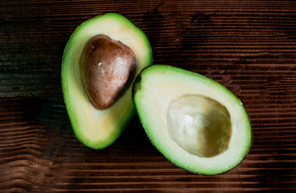 istock isolated avocado on a dark wood and white background. selective focus 1193472652