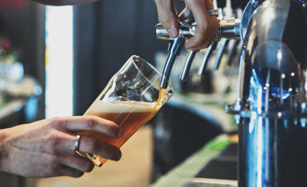 istock bartender hand at beer tap pouring a draught beer in glass serving in a restaurant or pub 1193474210