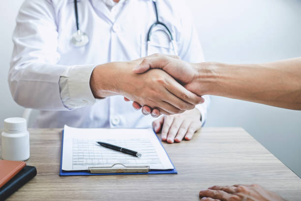 istock Doctor having shaking hands to congrats with patient after recommend treatment while discussing explaining his symptoms and counsel diagnosis health, healthcare and assistance concept 1193474447
