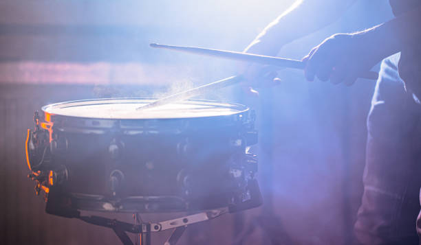 istock man playing the snare drum on a beautiful colored background 1193474488