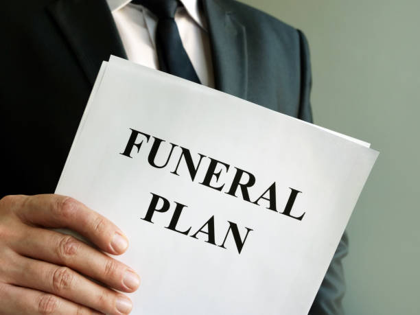 Man holds Funeral plan and stack of papers. Man holds Funeral plan and stack of papers. funeral planning stock pictures, royalty-free photos & images