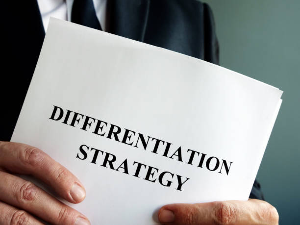 istock Businessman holds differentiation strategy and business papers. 1193484124