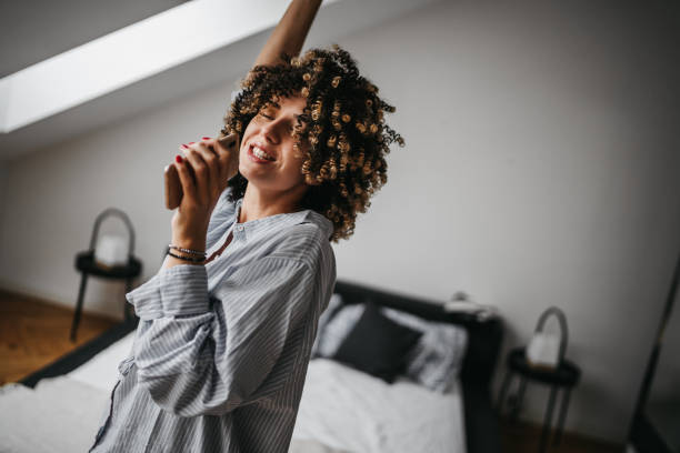 istock Happy young woman at home 1193484246