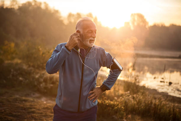 istock Senior Caucasian man after jogging checking headphones 1193484553