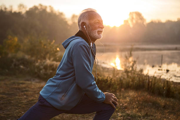 istock Mature man stretching legs getting ready for running near lake 1193484606