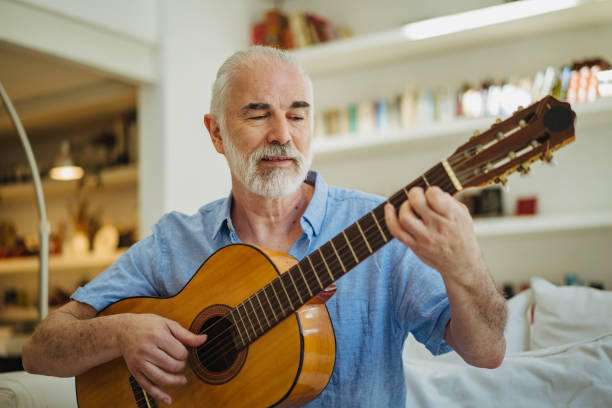 istock Senior man playing acoustic guitar 1193485198