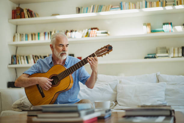 istock Senior man playing acoustic guitar 1193485348