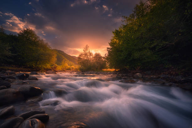 istock beautiful sunrise over fast flowing mountain river 1193485402