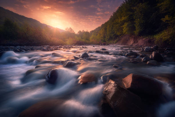 istock beautiful sunrise over fast flowing mountain river 1193485435