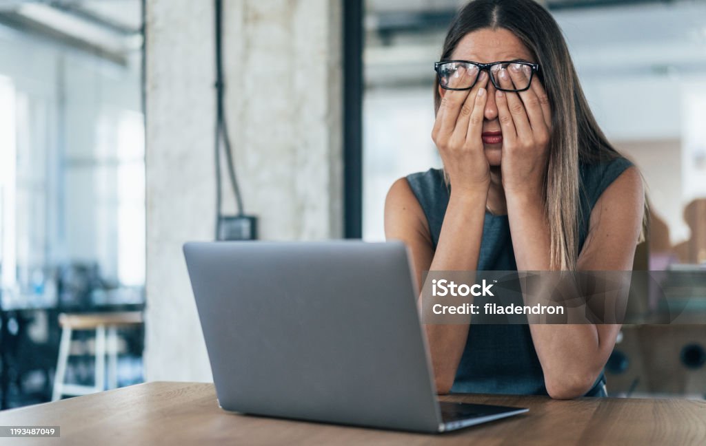 Tired Business woman Business woman with hands on her face looking exhausted Emotional Stress Stock Photo