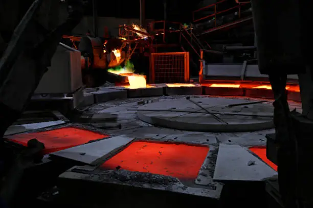 Photo of View of the anode copper casting and molds in the smelting plant. Cast copper is obtained after melting the metal and poured into different molds for getting the final or the desired casted shape.