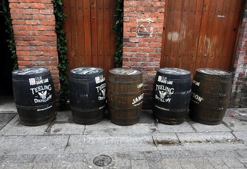 9th December 2019, Dublin, Ireland. Teeling Whiskey Distillery and Jameson Whiskey Distillery whiskey barrels outside 4 Dame Lane pub, Dublin city centre.