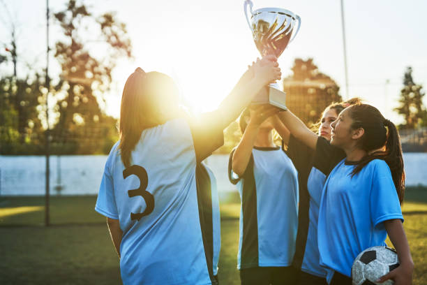 istock Soccer players with trophy celebrating success 1193487524