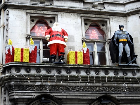 9th December 2019, Dublin, Ireland. A festive  Santa Clause and gifts next to Batman on the National Wax Museum building exterior first floor window ledge on Westmoreland Street, Dublin.