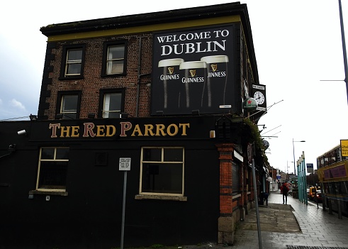 9th December 2019, Dublin, Ireland. The Red parrot pub on Dorset Street Lower with a Guinness 'Welcome to Dublin' poster.