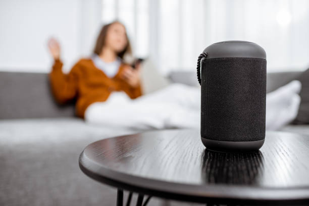 istock Woman controlling home devices with a voice commands 1193488792