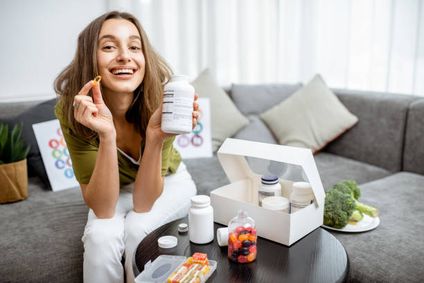 istock Woman with nutritional supplements at home 1193488899