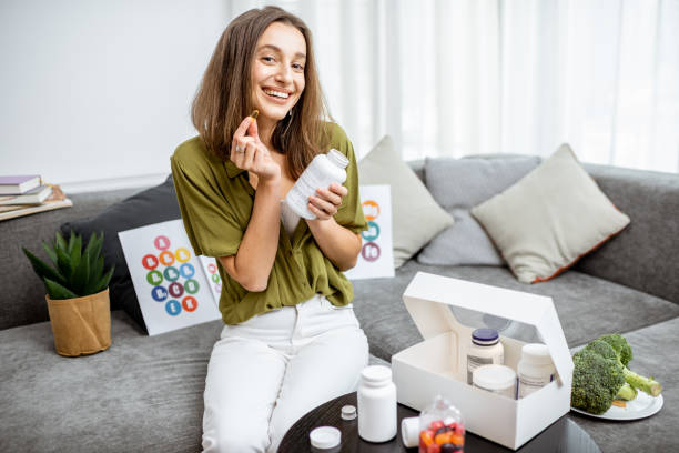 istock Woman with nutritional supplements at home 1193488901