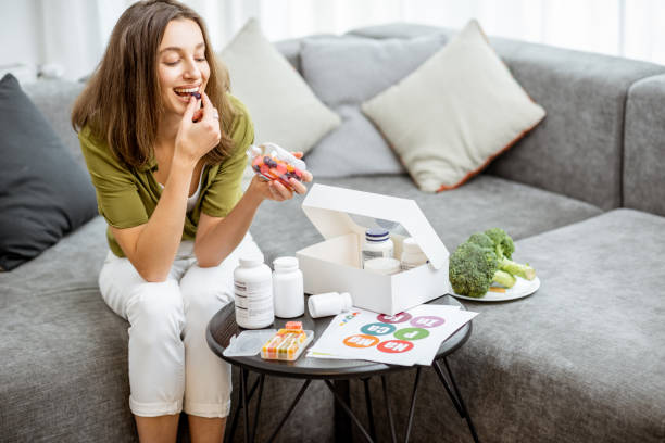 istock Woman taking vitamins or nutritional supplements 1193488909