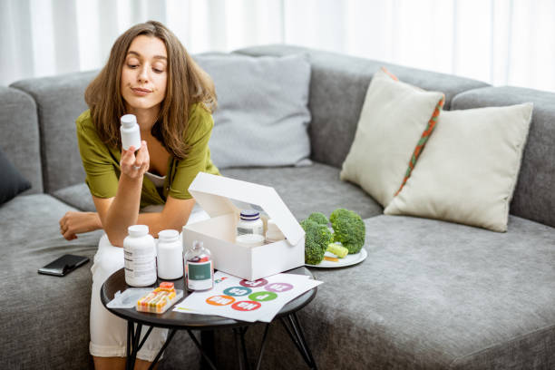 istock Thoughtful woman with vitamins or nutritional supplements at home 1193488927