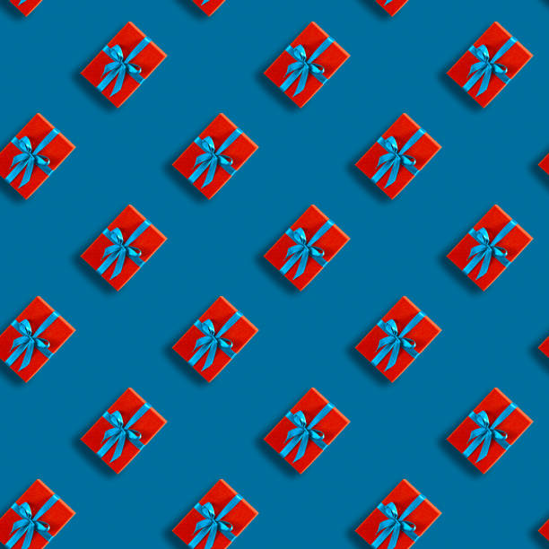 istock Seamless Christmas pattern with Xmas gift red box on classic blue background. 1193488970