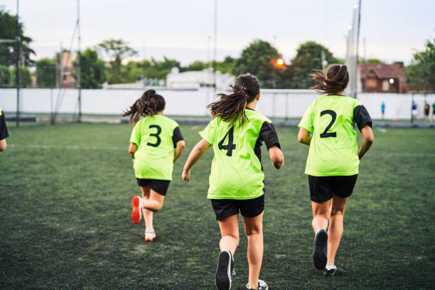 Female soccer players warming up before match