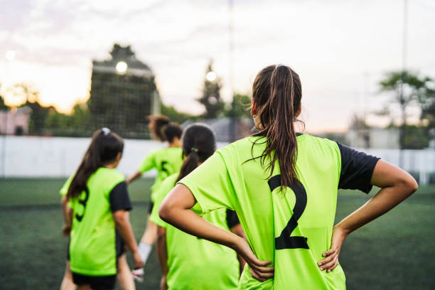 istock Sports team playing soccer on field 1193489737