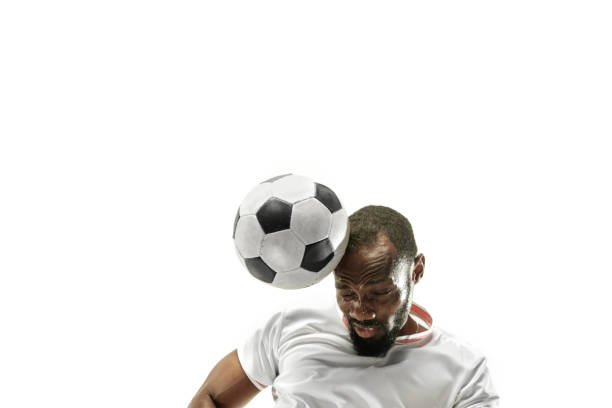 Close up of emotional man playing soccer hitting the ball with the head on isolated white background Close up of emotional african man playing soccer hitting the ball with the head on isolated white background. Football, sport, facial expression, human emotions, healthy lifestyle concept. Copyspace. head shoot stock pictures, royalty-free photos & images