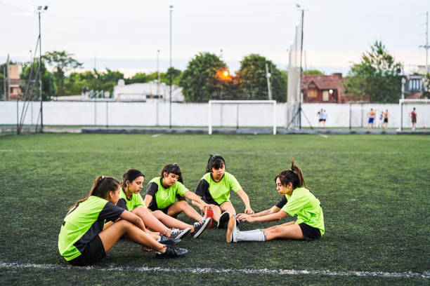 istock Soccer girls stretching before match on field 1193489817