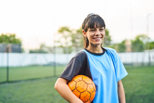 istock Happy soccer player with ball on field 1193490278