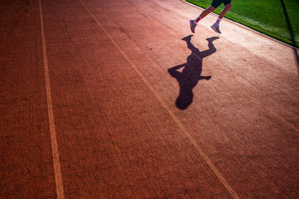 istock Alone runner train on the track, silhouette photo.. red Track and field background 1193491149