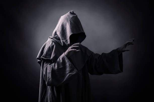 istock Scary figure in hooded cloak 1193491499
