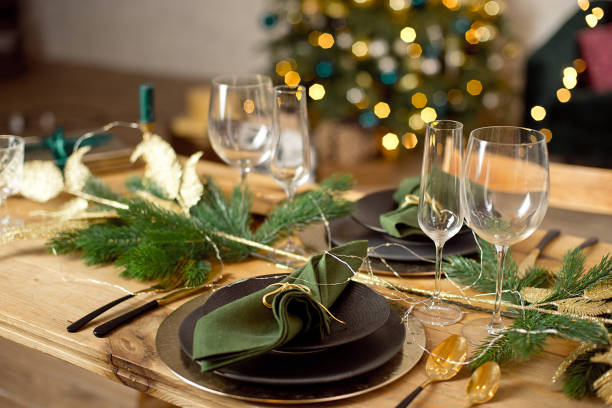 istock Table served for Christmas dinner in living room, close-up view, table setting, Christmas decoration. 1193492653
