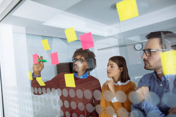istock Business people brainstorming ideas behind glass wall 1193492841