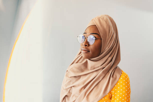 istock Concerned black muslim woman looking through a window 1193493128