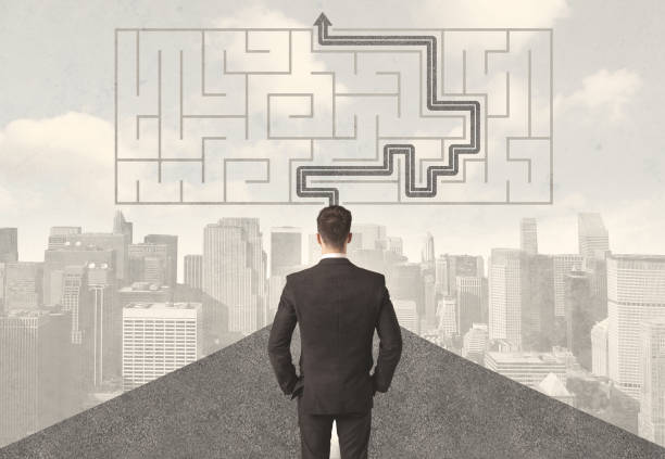 istock Businessman looking at road with maze and solution 1193494074