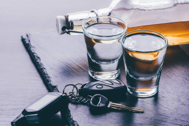 glasses with alcohol and car keys glasses with alcohol and car keys on a dark background driving under the influence stock pictures, royalty-free photos & images