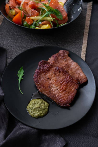 istock fried meat with vegetable salad and pesto. 1193495504