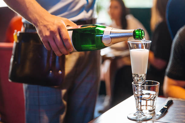 istock The waiter pours champagne 1193495810
