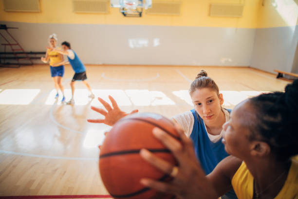 istock Ladies playing basketball indoors 1193496866