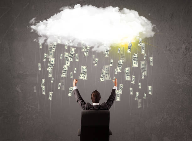 istock Business man in suit looking at cloud with falling money 1193497094